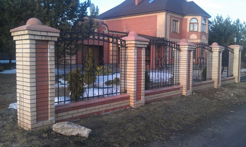 Кованый забор с кирпичными столбами