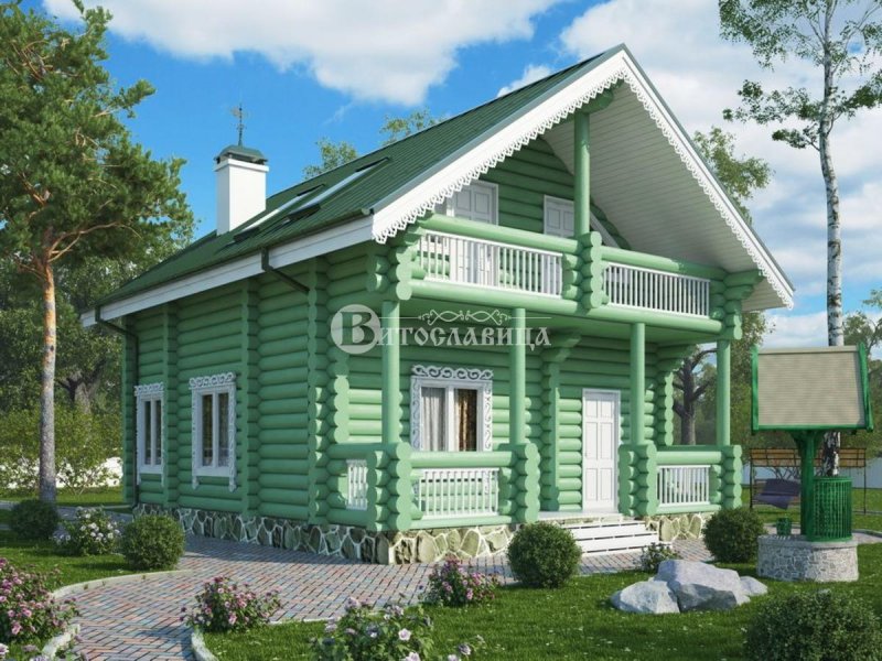Бревенчатый дом с зеленой крышей